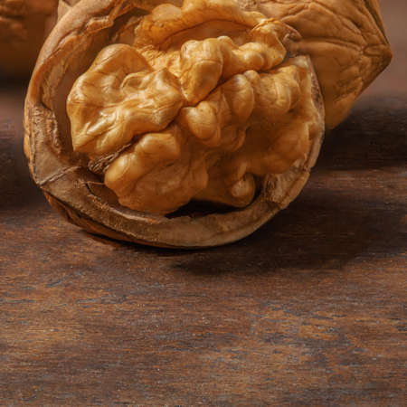 Walnuts on dark vintage table. Walnuts kernels with green leaves. Copyspace.の写真素材