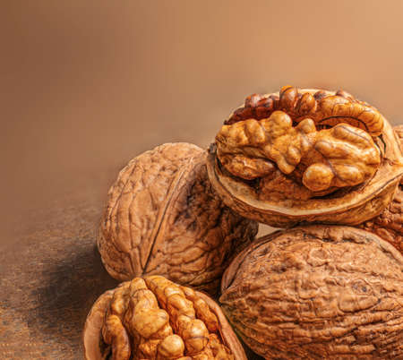 Walnuts on dark vintage table. Walnuts kernels with green leaves. Copyspace.の写真素材