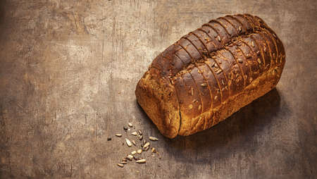 Wholegrain Bread on dark wooden background. Bakery, rustic traditional food concept. Top viewの写真素材
