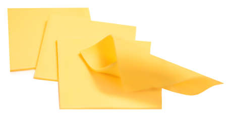 Slices of cheese for sandwiches isolated on white background, top view. cutted cheese closeupの写真素材