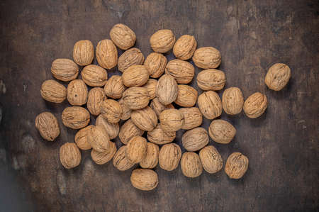 Ripe Walnuts on a wooden table. Walnut fresh nuts Background top viewの写真素材