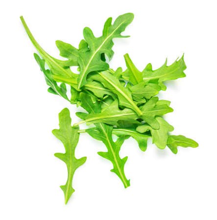 Pile of Green rucola leaves isolated on white background. fresh arugula closeupの写真素材