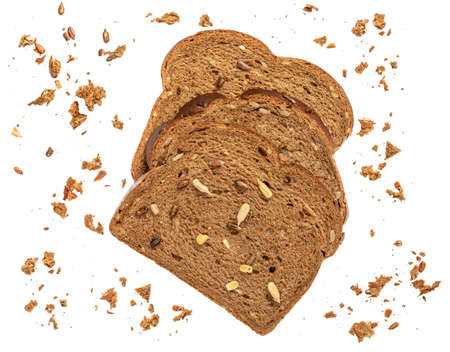 Sliced wholegrain bread isolated on white background with seeds and crumbs, closeup.の写真素材