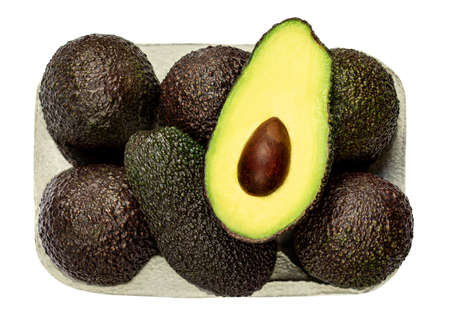 Fresh avocado isolated on white background. Black Hass avocado in a paper basket closeup.の写真素材