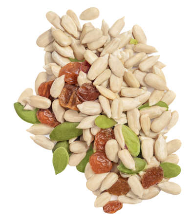 Heap of nuts and seeds isolated over the white background. Creative layout made of dried fruits and seeds. Healthy breakfast. flat lay. food concept.の写真素材