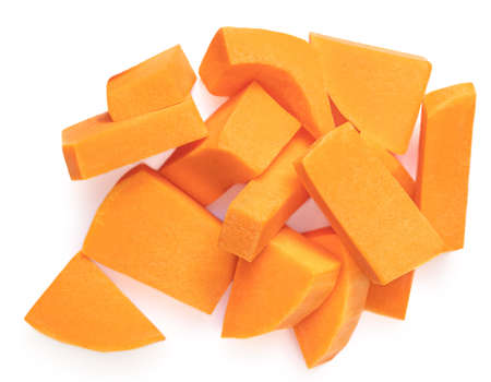 Pumpkin pieces cut in a cube slice isolated on white background. Diced Pumpkin top viewの写真素材