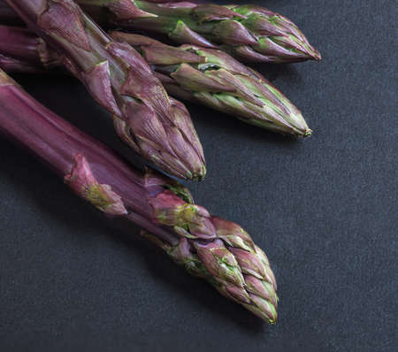 Asparagus. Bunch of fresh asparagus on black slate background. top view. copy spaceの写真素材