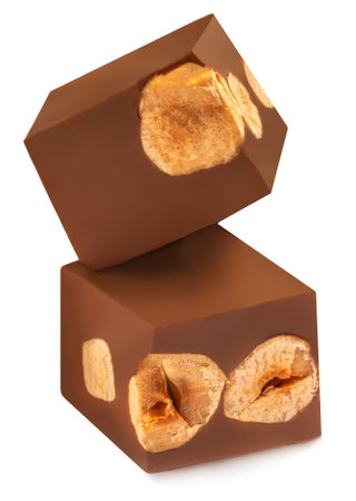 Cubes of milk chocolate bar with nuts isolated on white backgroundの写真素材