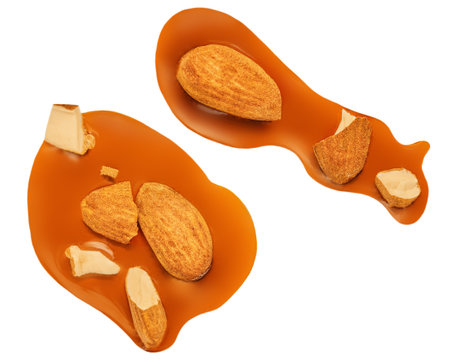 Caramel with almond nuts and caramel sauce isolated on a white background close up. top view. flat layの写真素材