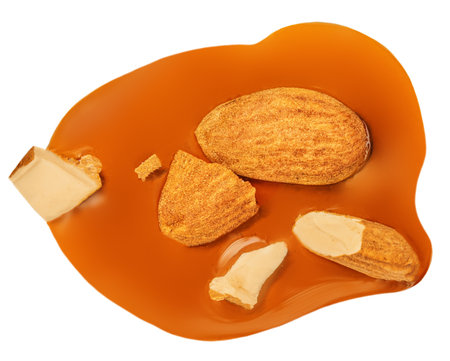 Caramel with almond nuts and caramel sauce isolated on a white background close up. top view. flat layの写真素材