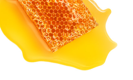 Honeycomb with honey syrup isolated on white background. Honey flat lay. food concept.の写真素材