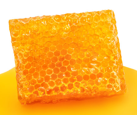 Honeycomb with honey syrup isolated on a white background. Honey food concept.の写真素材
