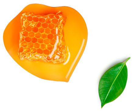 Honeycomb with honey syrup isolated on white background. Honey, green leaves Flat lay. food concept.の写真素材