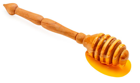 Honey dipper stick isolated on a white background.の写真素材