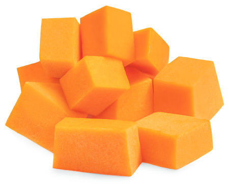 Pumpkin squash slices isolated on white background. Pumpkin pieces cutted in a cubes close up.の写真素材