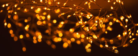 Christmas golden lights background. Abstract twinkled bright bokeh defocused lightsの写真素材