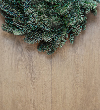 Christmas fir tree on dark wooden background top view, flat lay. Xmas wreath. Nature New Year concept.の写真素材