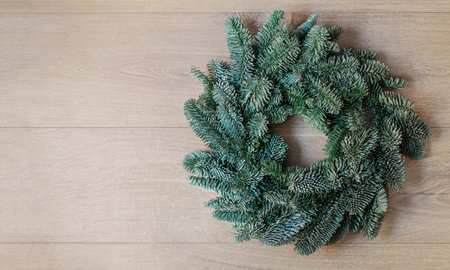 Christmas fir tree on dark wooden board top view, flat lay. Xmas wreath. Nature New Year concept.の写真素材