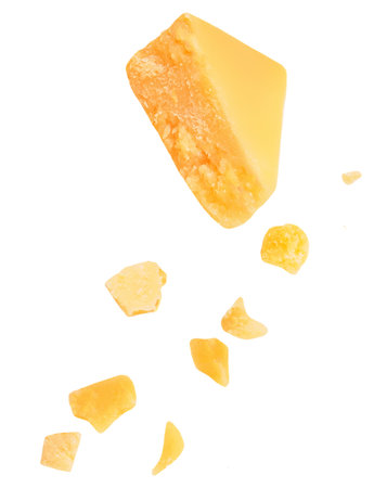 Flying Parmesan cheese pieces isolated on white background. Hard mature cheese Parmigiano top view, flat lay. patternの写真素材