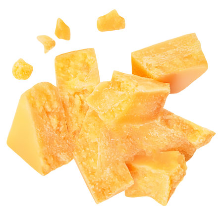 Parmesan cheese pieces isolated on white background. Hard mature cheese Parmigiano top view, flat lay.の写真素材