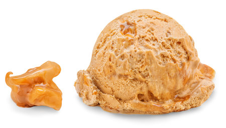 Caramel Ice cream scoop isolated on a white background with caramel pieces closeupの写真素材
