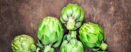 Artichoke buds. Fresh raw artichoke on wooden background close upの写真素材