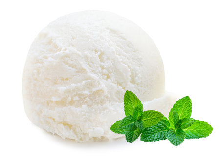 Scoop of vanilla ice cream ball isolated on white background with green mint leafの写真素材