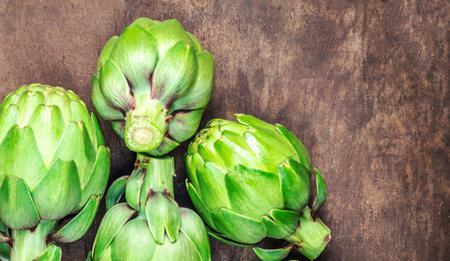 Artichoke flower buds. Fresh raw artichoke on wooden background close upの写真素材