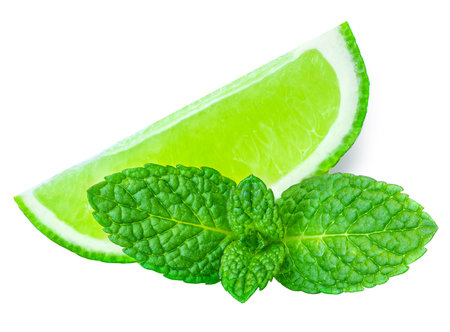 Lime slices isolated on white background. Lime citrus fruit with mint leafの写真素材