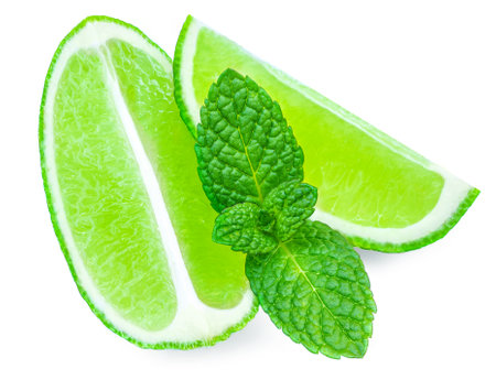 Lime slices isolated on white background. Lime citrus fruit with mint leafの写真素材