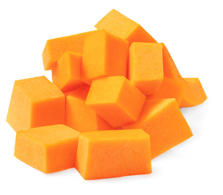 Diced Pumpkin isolated in white background. Pumpkin slices cut out, closeup.の写真素材