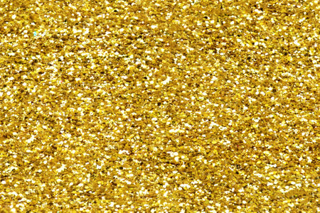 Gold glitter texture sparkling shiny background for Christmas card. Twinkly golden glitter lights grunge backgroundの写真素材