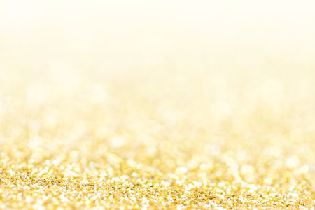 Golden lights Abstract Christmas background. Magic shining gold dust. Holiday New year Glitter Defocused Backgroundの写真素材