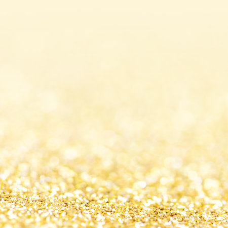 Golden lights Abstract Christmas background. Magic shining gold dust. Holiday New year Glitter Defocused Backgroundの写真素材