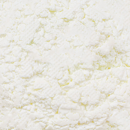 Cottage cheese pattern. Fresh grainy cottage cheese or feta diary product as a textured backgroundの写真素材