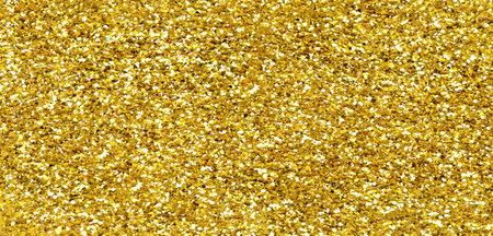 Gold glitter texture sparkling shiny background for Christmas card. Twinkly golden glitter lights grunge backgroundの写真素材