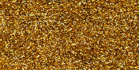 Gold glitter texture sparkling shiny background for Christmas card. Twinkly golden glitter lights grunge backgroundの写真素材