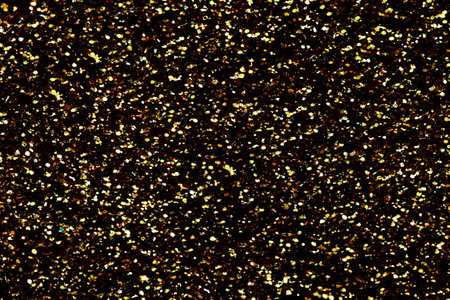 Gold glitter texture sparkling shiny background for Christmas card. Twinkly golden glitter lights grunge backgroundの写真素材