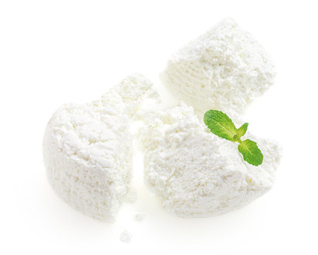 Cottage cheese isolated on white background closeup. Fresh grainy cottage cheese or feta with mint for package designの写真素材