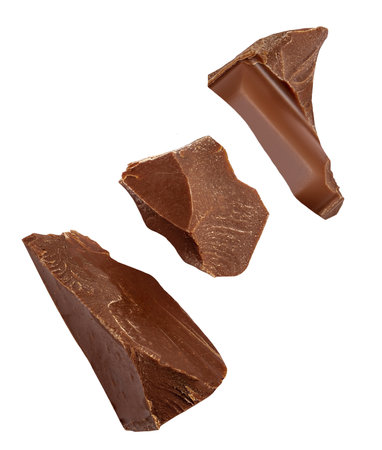 Levitating milk chocolate chunks isolated on white background. Crumbs, shavings and Flying Chocolate pieces Top view. Flat layの写真素材