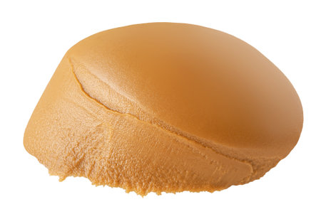 Creamy peanut butter isolated on white background. Piece of Peanut paste closeup