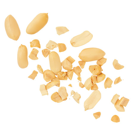 Peanuts levitating in air on white background. Isolated Falling crushed peanuts. Peanut explosion