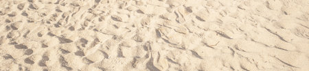 Summer beach sand background with natural wave pattern. Sand texture. Sunny gold sandy beach wallpaperの写真素材