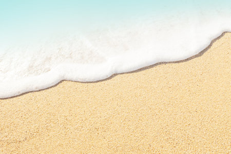 Blue ocean wave on sandy beach top view. Summer sunny empty Tropical sea beach with copy space.の写真素材