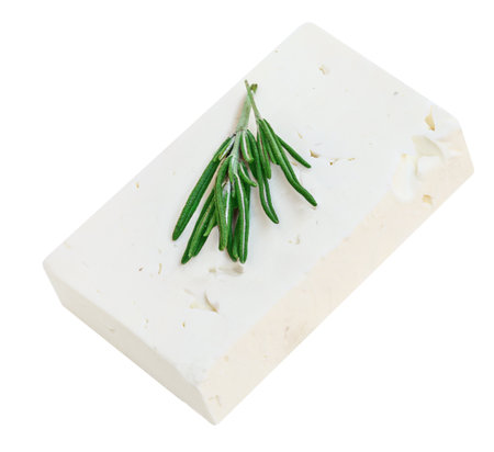 Feta cheese isolated. Greek fitaki cheese pieces on white background. Feta block with rosemary herb Top view. Package design elementの写真素材