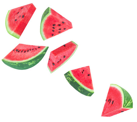 Watermelon fruit Explosion. Levitating Watermelon triangle slices isolated on white. Falling watermelon pieces with seeds. Pattern Summer Creative layoutの写真素材