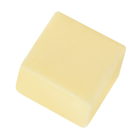 Butter cube isolated on white background. Fresh cow's milk butter piece close up.の写真素材