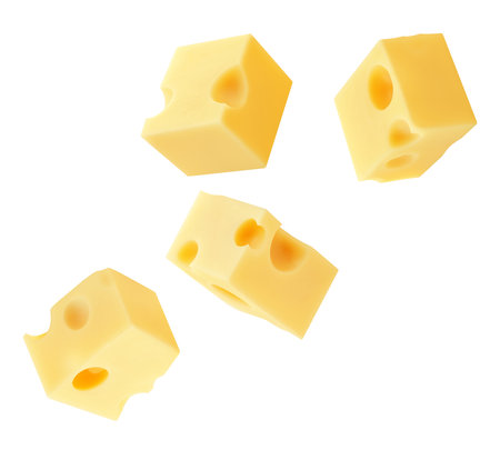Flying Cheese pieces isolated on white. Levitating maasdam cheese cubes. Holey Cheese Explosion. Top view. Flat lay. Package design element. Creative layoutの写真素材