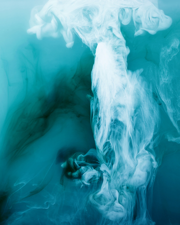 Blue and white acrylic paints inside the water on a blue background. Watercolor style and abstract image of sea or ocean.の写真素材