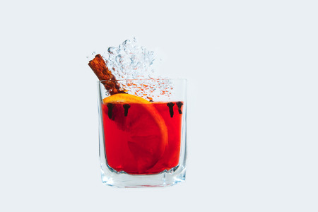 Mulled wine in a glass isolated in water on a white background. Red juice is under the water with bubbles.の写真素材